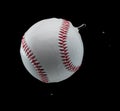 Baseball ball hit water and splash in air. Baseball ball fly in rain and splatter splash in droplet water. Black background