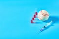 Baseball ball near syringe and ampoule on blue background. Concept of doping in professional sport Royalty Free Stock Photo