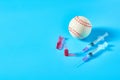 Baseball ball near syringe and ampoule on blue background. Concept of doping in professional sport Royalty Free Stock Photo