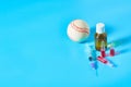 Baseball ball near syringe and ampoule, bottle on blue background. Concept of doping in sport Royalty Free Stock Photo