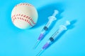 Baseball ball near syringe on blue background. Concept of doping in professional sport Royalty Free Stock Photo