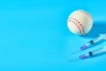 Baseball ball near syringe on blue background. Concept of doping in professional sport Royalty Free Stock Photo