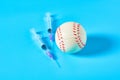 Baseball ball near syringe on blue background. Concept of doping in professional sport Royalty Free Stock Photo