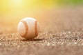 Baseball ball on pitchers mound. Baseball field at sunset