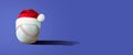 Baseball ball in Santa Claus hat, on a blue background. Copy space. Place for your text. New Year`s banner Royalty Free Stock Photo