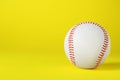 Baseball ball on yellow background, closeup with space for text. Sports game Royalty Free Stock Photo