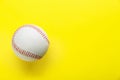 Baseball ball on yellow background, top view with space for text. Sports game Royalty Free Stock Photo