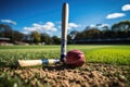 Baseball bat and ball on a green grass of baseball field. AI Generated Royalty Free Stock Photo