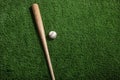 Baseball bat and ball on green turf background Royalty Free Stock Photo