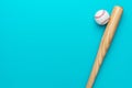 Baseball bat and ball on turquoise blue background Royalty Free Stock Photo