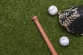 Baseball bat, glove and ball on green grass field.  Sport theme background with copy space for text and advertisment Royalty Free Stock Photo