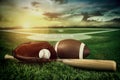 Baseball, bat, and mitt in field at sunset Royalty Free Stock Photo