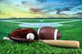 Baseball, bat, and mitt in field at sunset Royalty Free Stock Photo