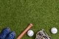 Baseball bat,shoes, glove and ball on green grass field. Sport theme background with copy space for text and advertisment Royalty Free Stock Photo