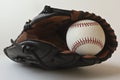 A Baseball in a Brown and Black Glove