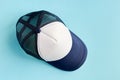 Baseball cap on blue background composition. Flat lay Royalty Free Stock Photo