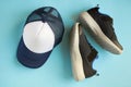 Baseball cap and sneakers on blue background composition Royalty Free Stock Photo