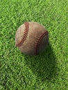 Baseball on the clear green grass turf close-up. Top view Royalty Free Stock Photo