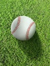 Baseball on the clear green grass turf close-up. Top view Royalty Free Stock Photo