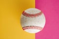Baseball closeup on pink and yellow background