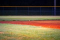 Baseball Floating inches above an empty baseball field at night time Royalty Free Stock Photo