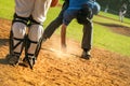 Baseball game, home plate umpire dusting of the home base during the ball game Royalty Free Stock Photo