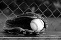 Baseball glove with ball in dugout Royalty Free Stock Photo
