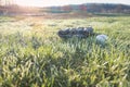 Baseball glove and ball on grass field with sun rising Royalty Free Stock Photo