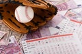 Baseball glove and ball near betting lists on euro and dollar banknotes Royalty Free Stock Photo