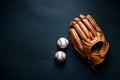 Baseball glove and balls isolated on dark background with copy space. Flat lay. Royalty Free Stock Photo