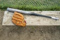Baseball bat and glove on a wood bench Royalty Free Stock Photo