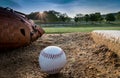 Baseball and glove on pitcher`s mound in early morning Royalty Free Stock Photo