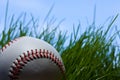 Baseball, grass and blue sky