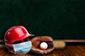 Baseball Helmet Wearing Mask With Chalkboard Background and Copy Space