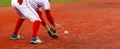 Baseball infielder fielding the ball on a red turf field