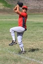 Baseball pitcher winds up to throw the ball Royalty Free Stock Photo