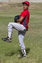 Baseball pitcher winds up to throw the ball