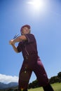 Baseball player with bat against sky on sunny day Royalty Free Stock Photo