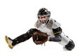 Baseball player, catcher in action in white sports uniform and equipment practicing isolated on a white studio Royalty Free Stock Photo