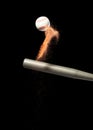 Baseball player hit ball with silver bat and sand soil explode in air. Baseball players in dynamic action hit ball smoke tail.