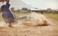 Baseball, baseball player running and diving for home plate in dirt during sport ball game competition on sand of