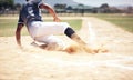 Baseball player, running slide and man on a base at a game with training and dirt. Dust, sport and male athlete outdoor Royalty Free Stock Photo