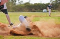 Baseball player sliding into third base