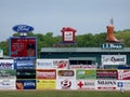 Baseball player stands in the outfield with ads on wall including LL Bean, Ford, Subway, Dunkin Donuts Royalty Free Stock Photo