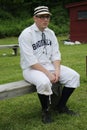 Baseball player in 19th century vintage uniform during old style base ball play