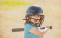 Baseball players kid swinging the bat at a fastball from the pitcher.