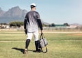 And so the baseball season begins. Rearview shot of a young man walking onto a baseball field.