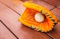 Baseball, Softball with leather mitt glove on wood table floor background with copy space. Sport Recreation Theme Royalty Free Stock Photo