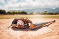 Baseball, sport and empty with a bat, ball and mitt on a base plate on a pitch outdoor after a competitive game. Fitness Royalty Free Stock Photo