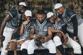 Baseball, sport and phone with a team of men on a bench after training, practice or a game. Teamwork, smartphone and Royalty Free Stock Photo